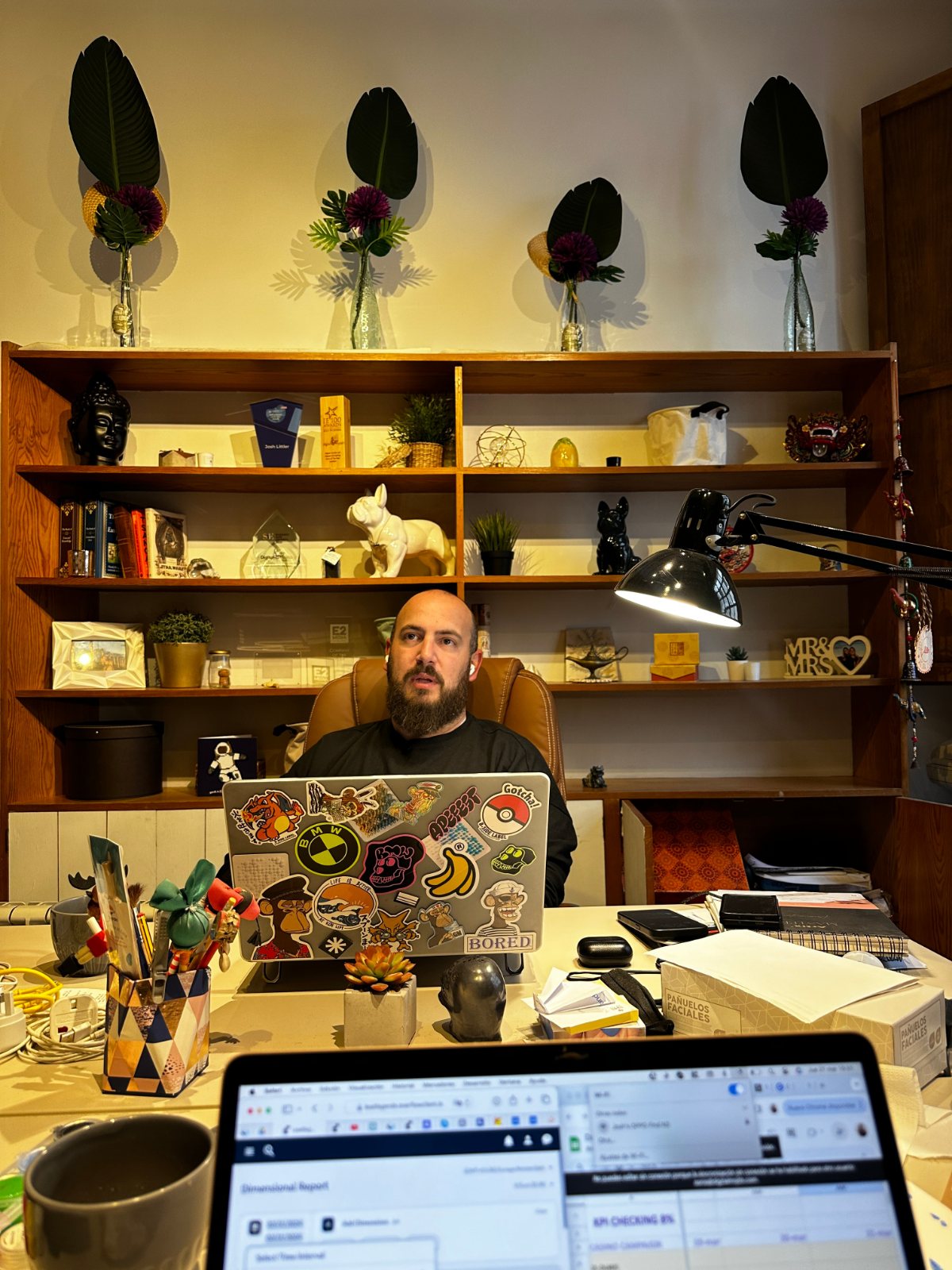 Josh seated behind a laptop at a desk