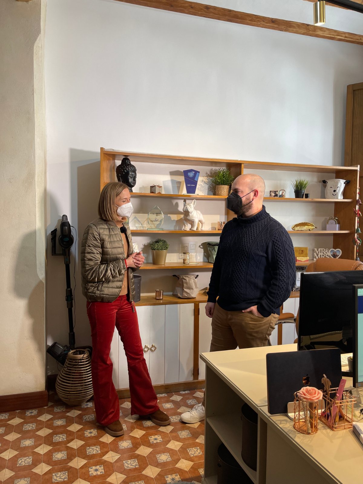 Two people standing in an office