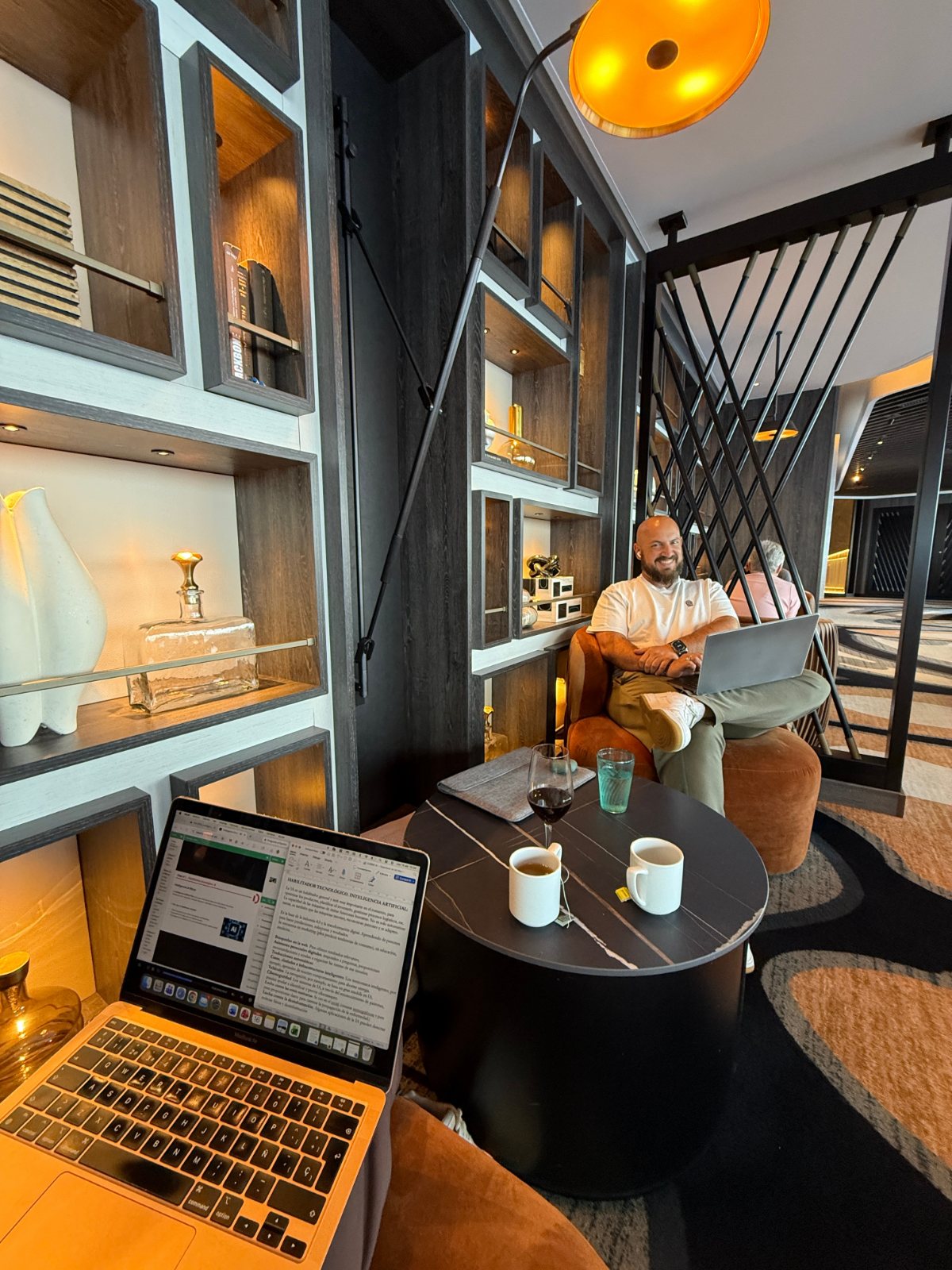 A person working at a laptop in a cafe