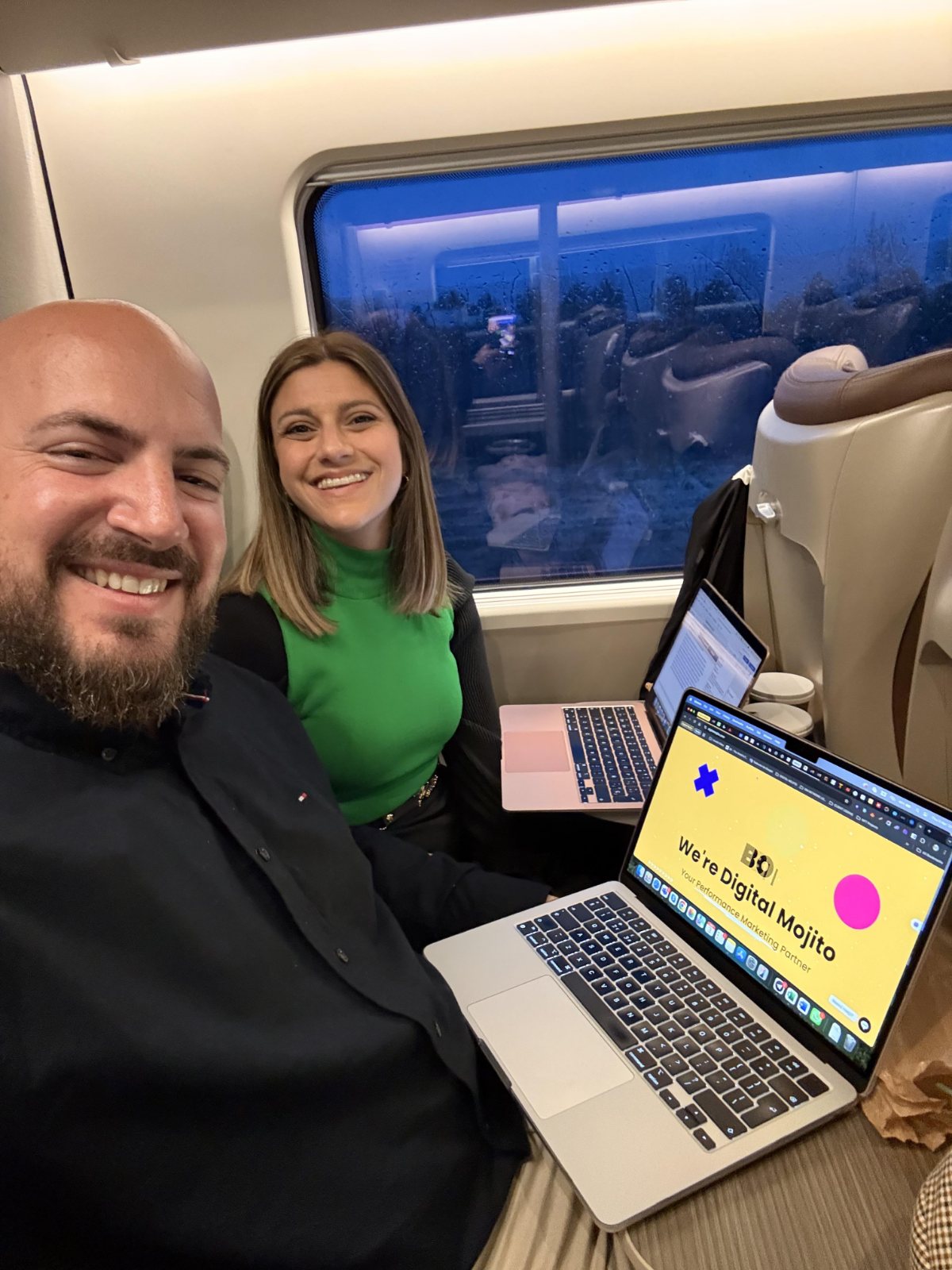 Josh and Sonia with laptops while travelling