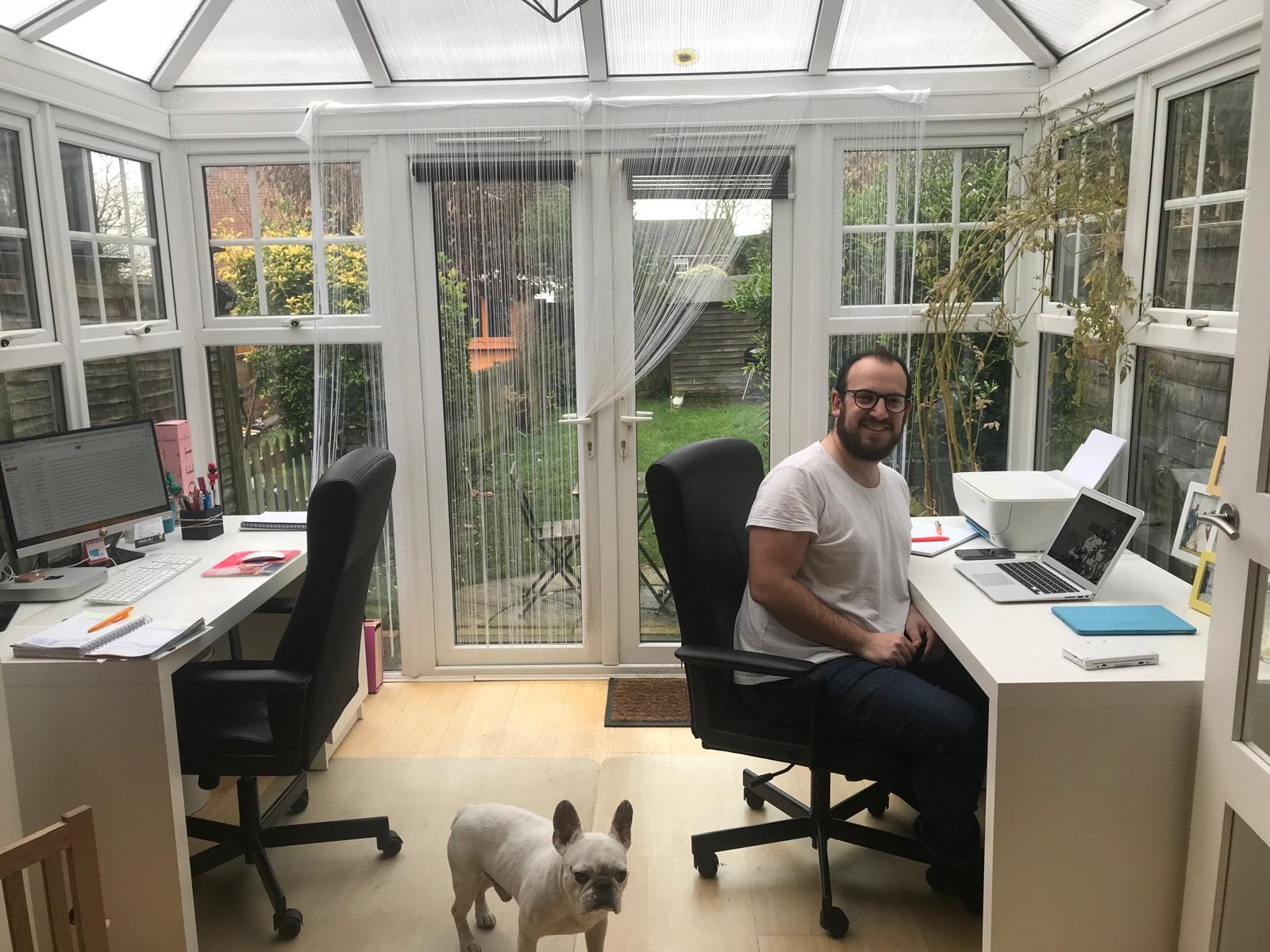 Josh at a desk in Digital Mojito’s early office, with a dog nearby