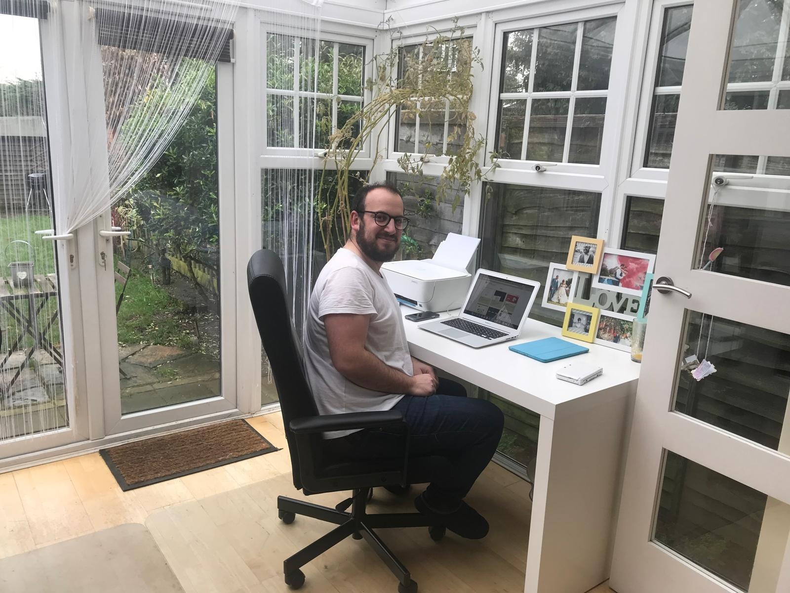 Josh seated at a desk in the early Digital Mojito office